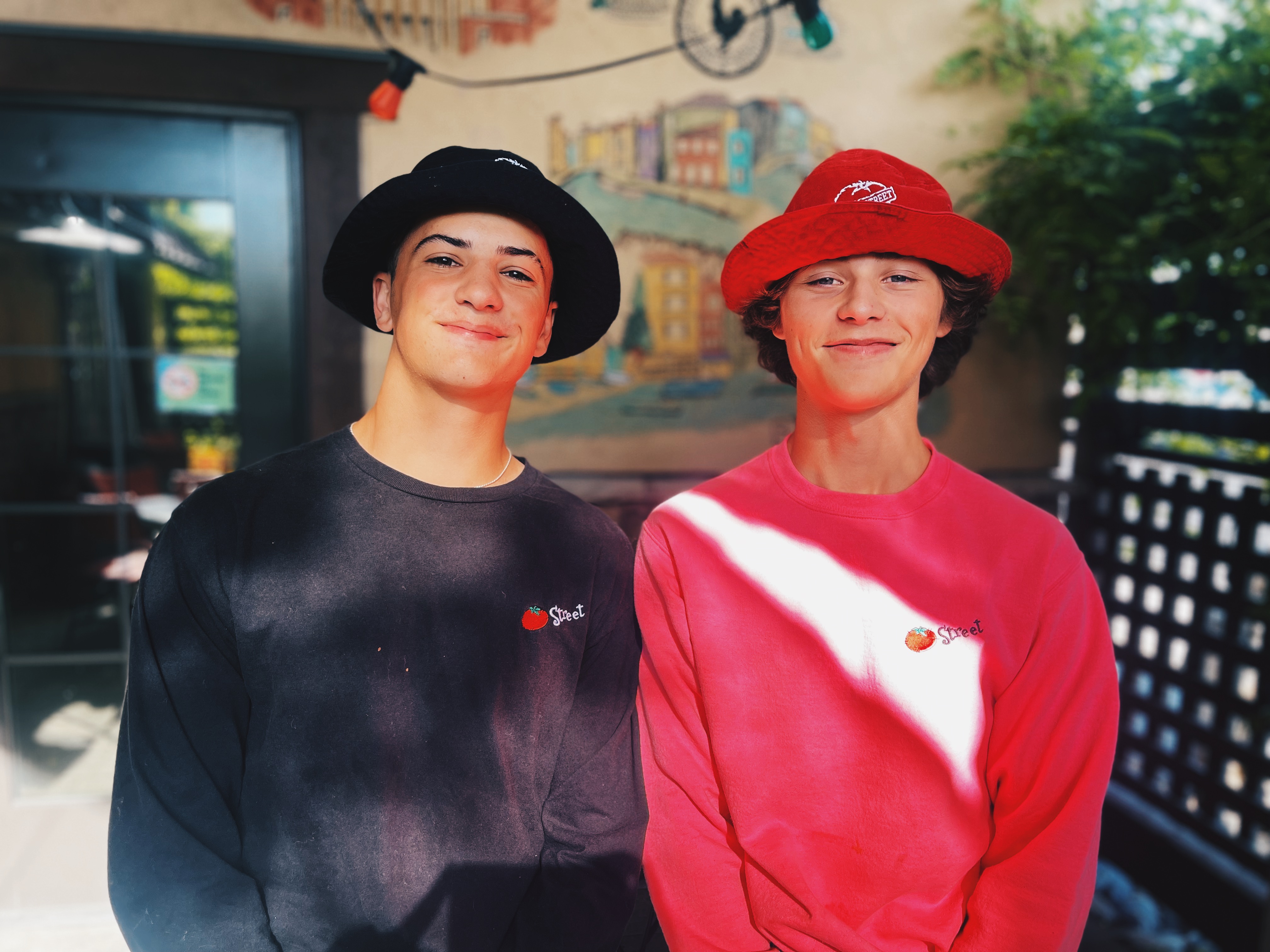 Two Tomato Street Employees standing together on the Tomato Street patio