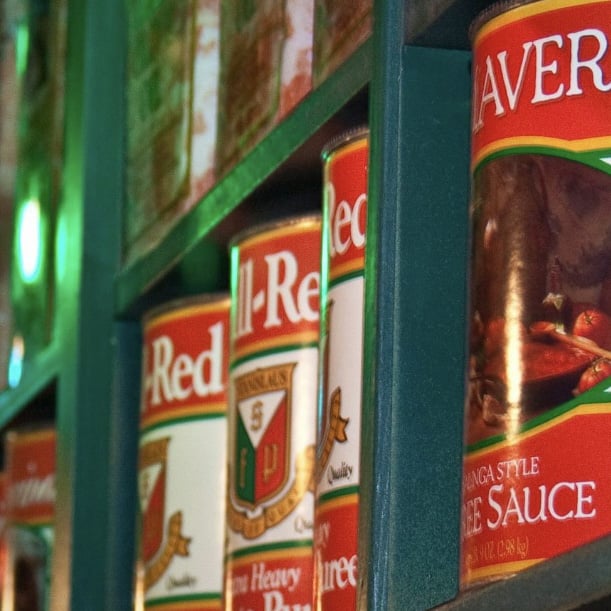 Tomato sauce cans lining the upper shelves of the restaurant
